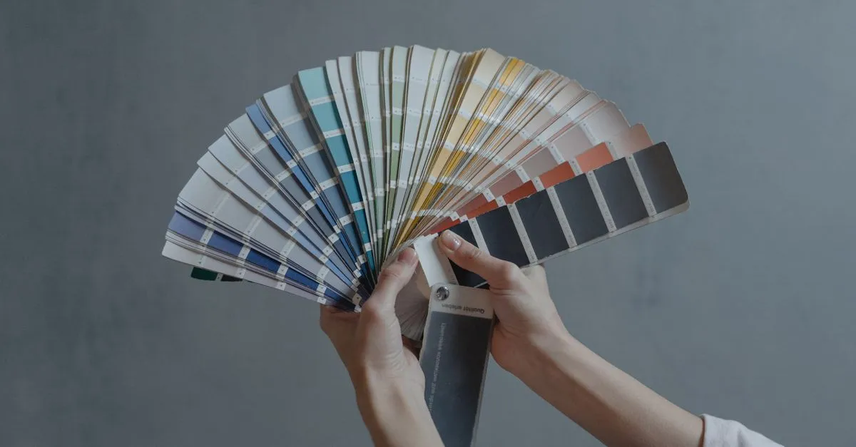 Designer's color swatches and palette samples spread on a work desk