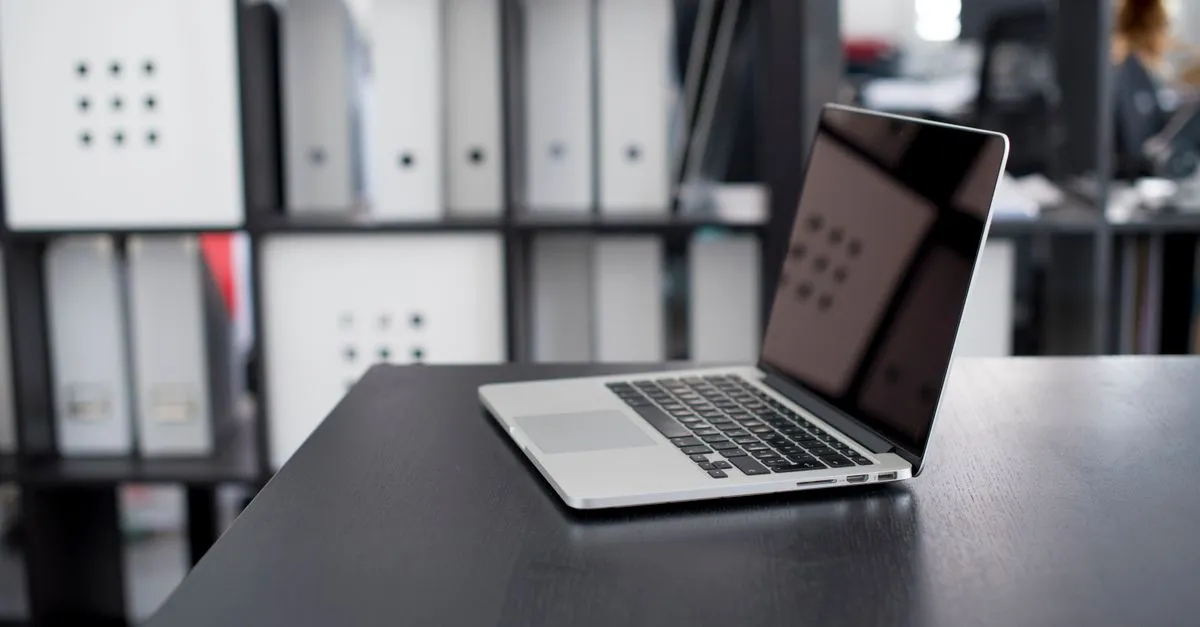 Photo files open on a laptop screen while compressing images to reduce file size