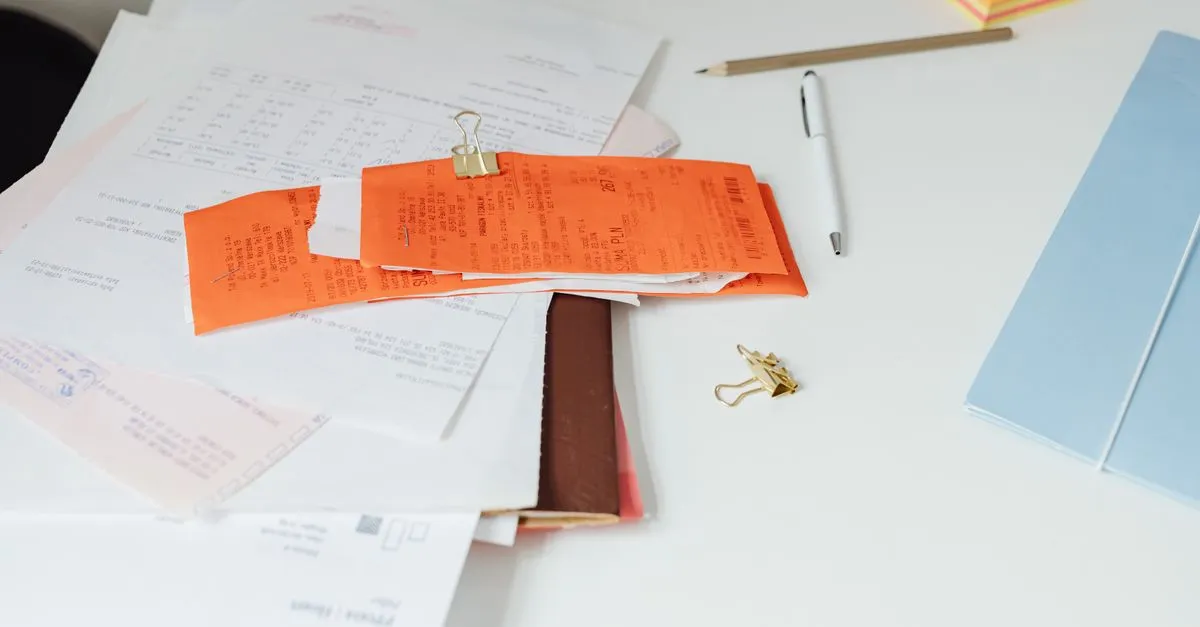 Stack of printed paper documents on a desk, ready to be merged into one PDF file