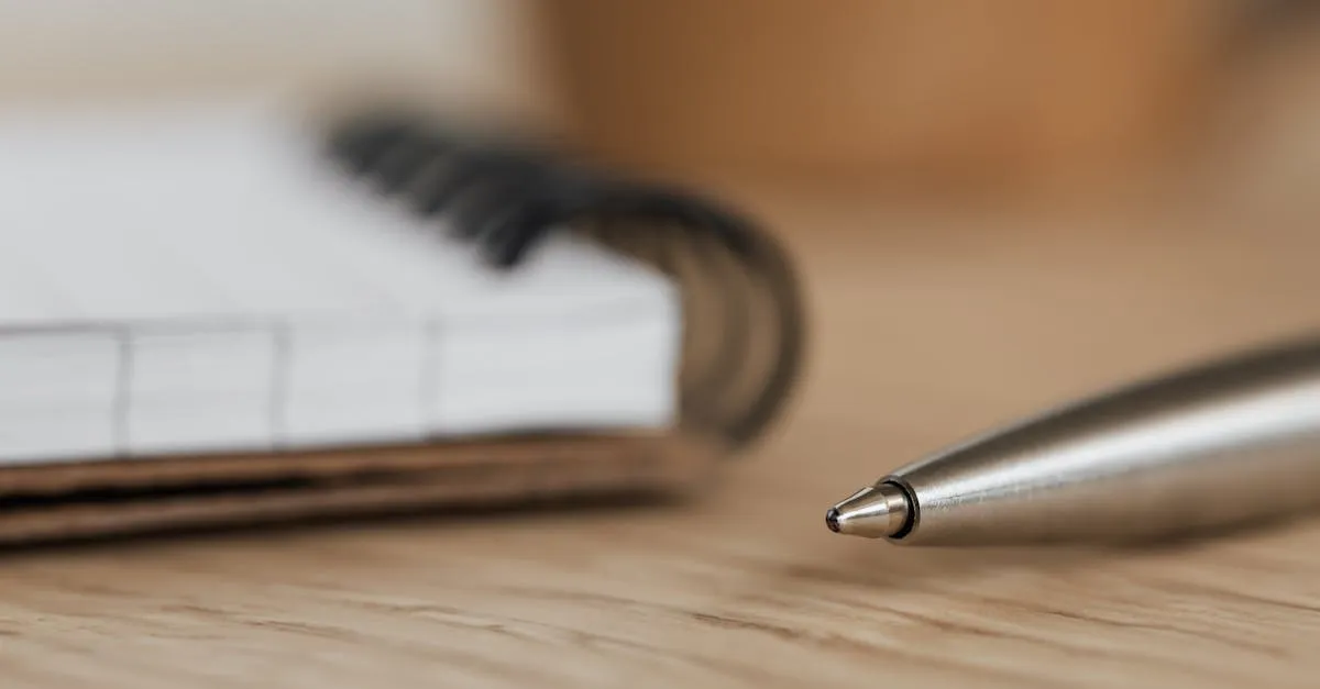 Hand writing in a notebook with pen on a wooden desk — text reversal and mirror writing