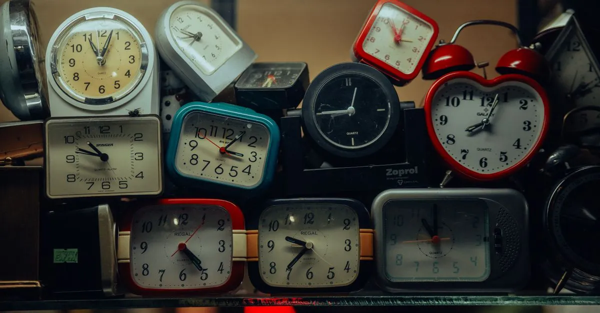 A row of wall clocks showing different times for cities in a timezone converter