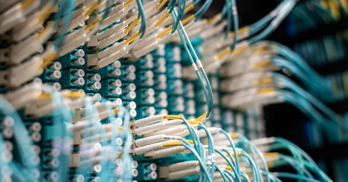 Server room with network cables and blinking lights routing internet traffic